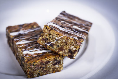 These granola bars were taken with a 50mm lens at F1.2. The lighting is two LED softboxes and a light ring on the lens. The white balance was purposely set cooler for a better effect.