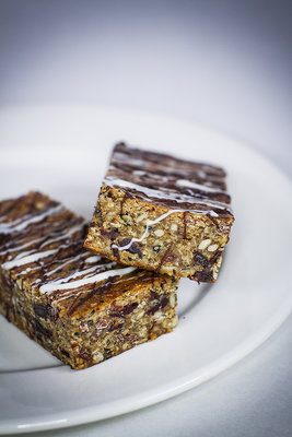 These granola bars were taken with a 50mm lens at F1.2. The lighting is two LED softboxes and a light ring on the lens. The white balance was purposely set cooler for a better effect.