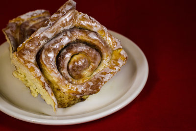 Probably my favorite shots of the entire series. The cinnamon bun were take with a red backdrop, plate and fork for added effect. They were taken with a 50mm lens at F1.2. The lighting consists of two LED softboxes and a ring light on the lens. The white balance is set warmer for added effect. I am getting hungry just looking at them...